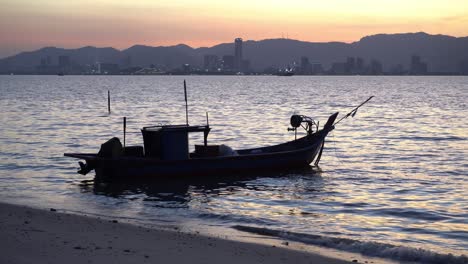 fishing boat with background komtar building