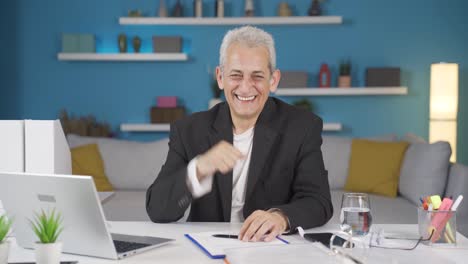 Home-office-worker-man-smiles-at-camera.