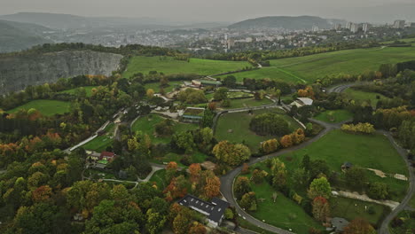 usti nad labem czechia aerial v5 panoramic panning view, drone flyover hillside zoo capturing industrial area by the bank of elbe river and massive quarry site - shot with mavic 3 cine - november 2022