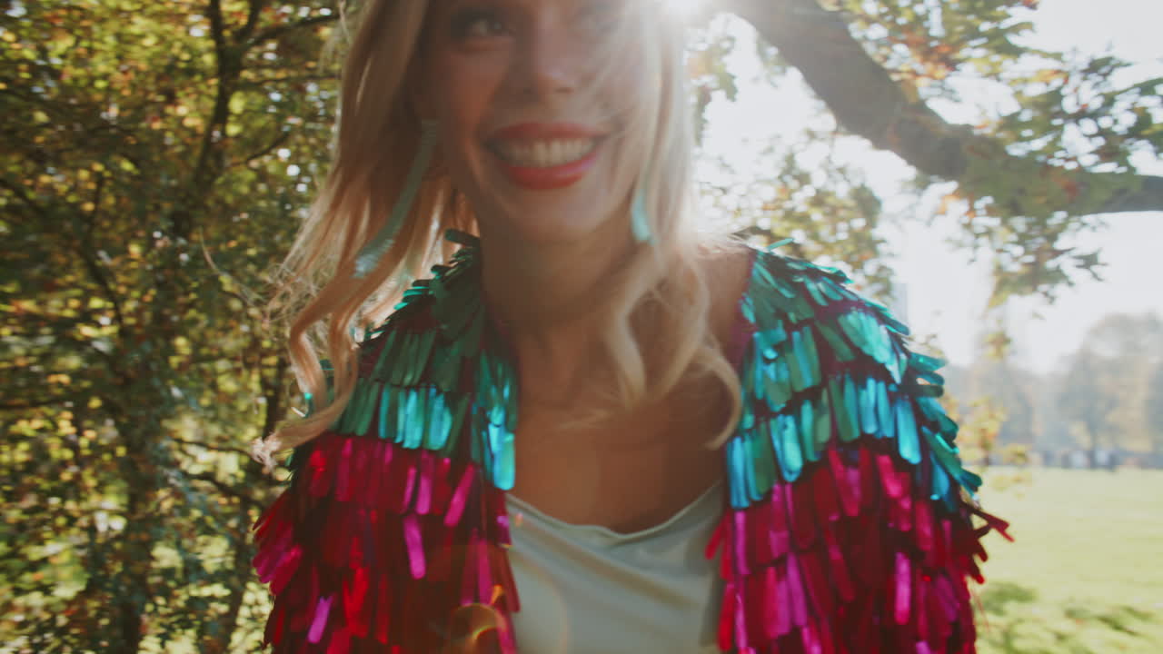 Woman in a Colorful Sequined Jacket in a Forest