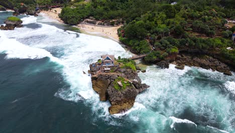 Drone-aerial-view-of-resort-with-tropical-beach-and-forest-on-Coral-Island,-Indonesia