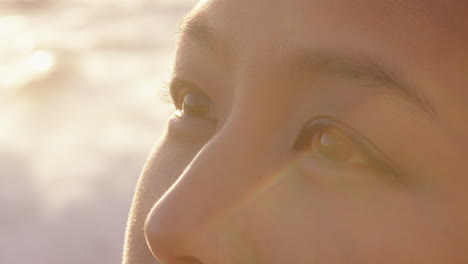 close up portrait of beautiful asian woman enjoying seaside at sunset exploring spirituality looking up praying contemplating journey relaxing on beach