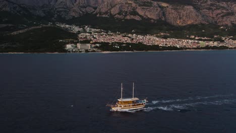 traditional cruise ship sailing near port town of makarska in dalmatia coastline, croatia