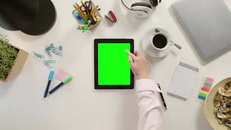 a finger scrolling on the green touchscreen