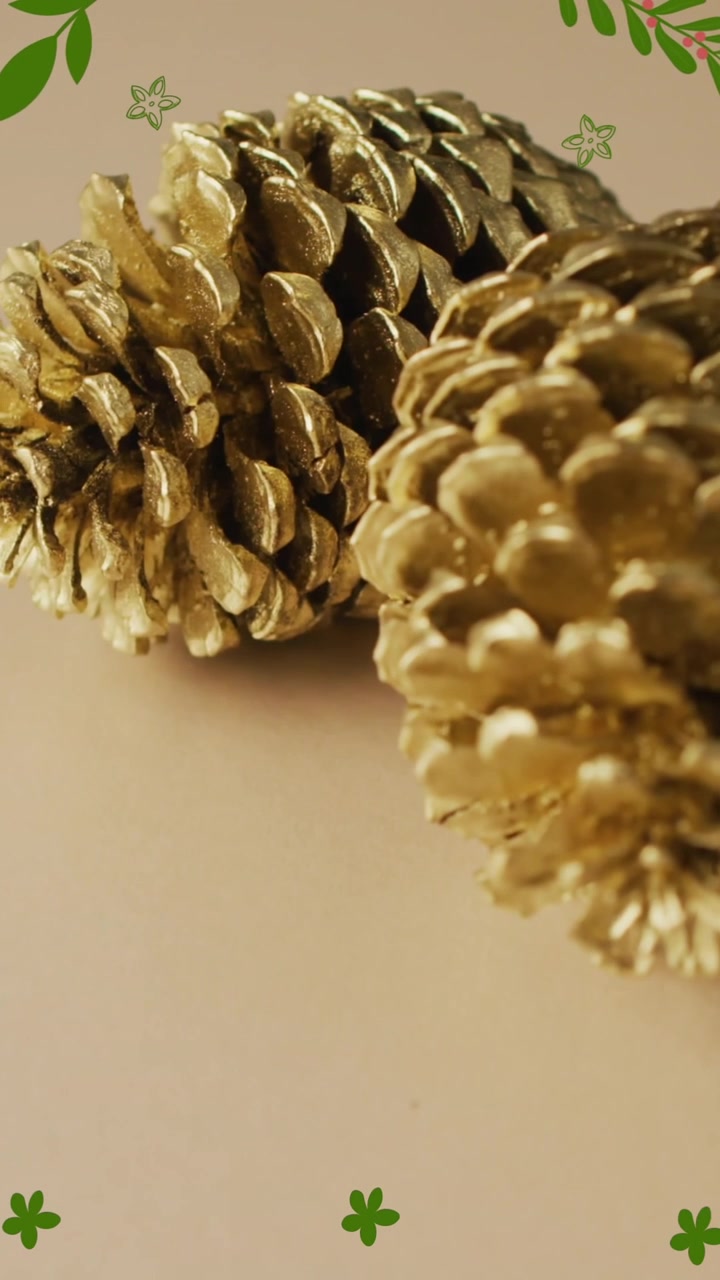 Animation of autumn leaves over pine cones on brown background