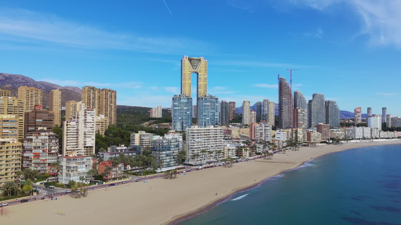 Benidorm's urban beach and high rise skyline extending along the Mediterranean coast