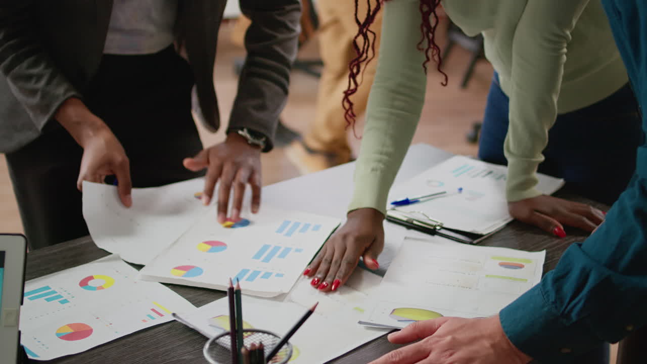 Business people analyzing charts information on documents