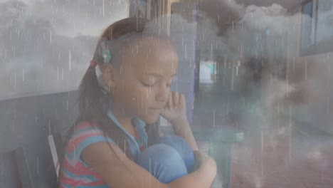 composite video of rainfall and thunderstorms against stressed african american girl at school