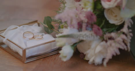 Wedding-Rings-In-Decorated-Box-With-Flowe-Background-