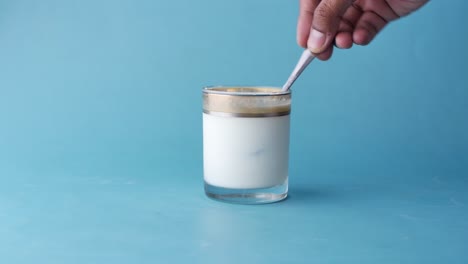 spoon pick whole cream from a glass of milk