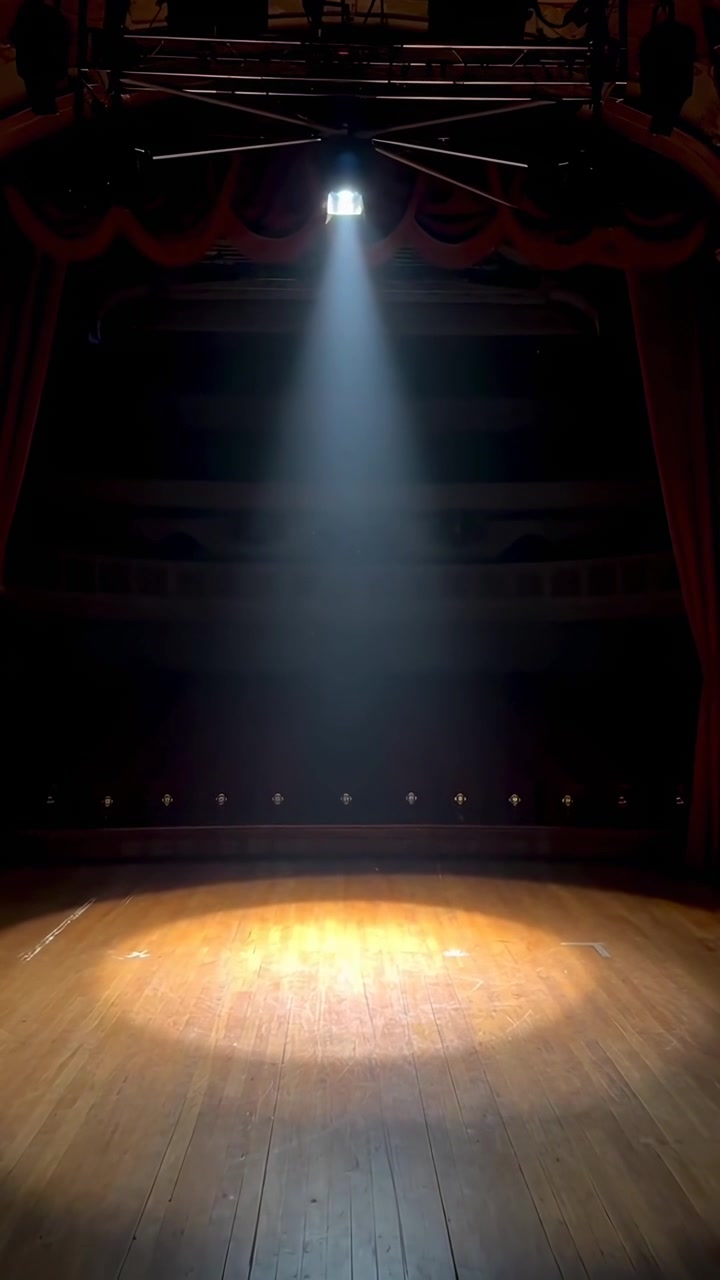 Spotlight Shining on an Empty Wooden Theater Stage