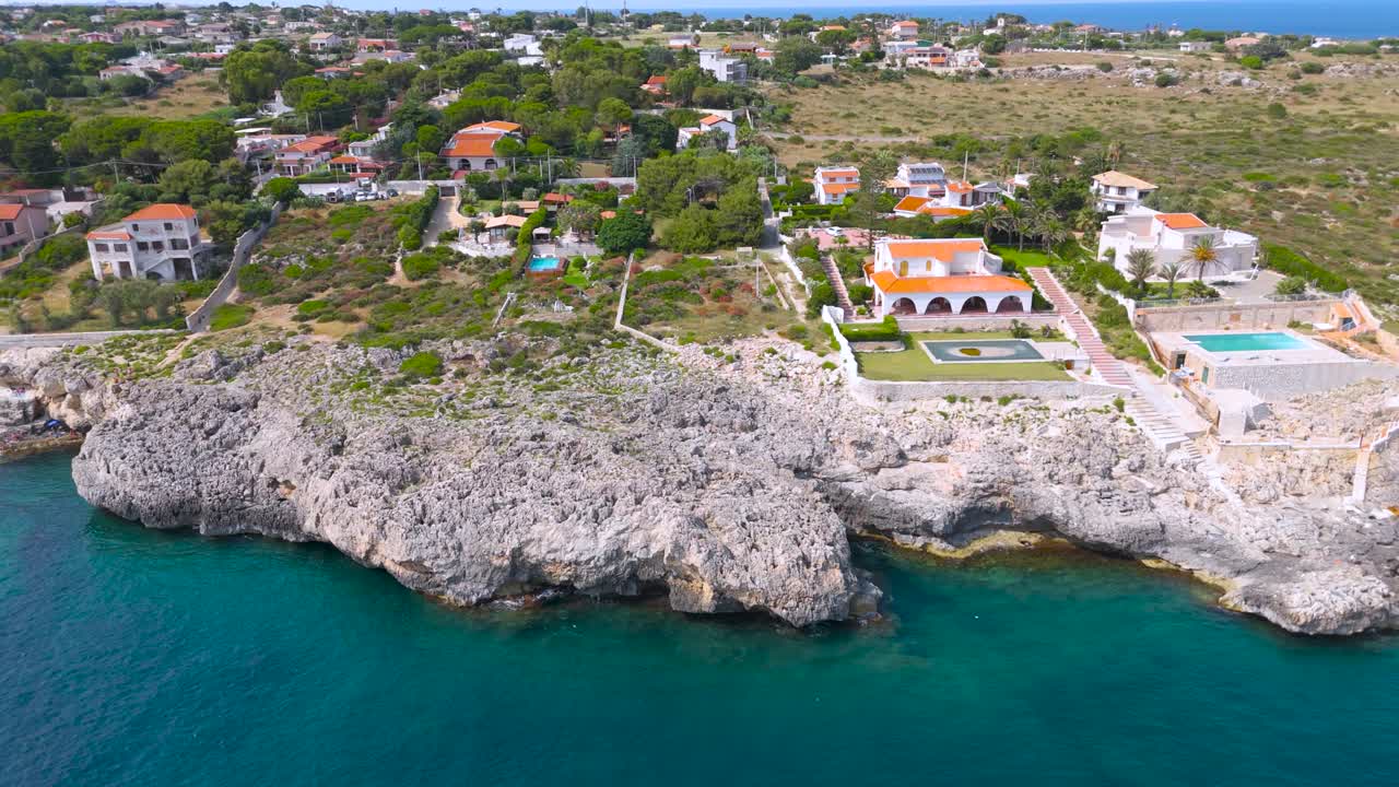 Aerial view of Plemmirio coastline, serene villas, blue sea in Sicilia