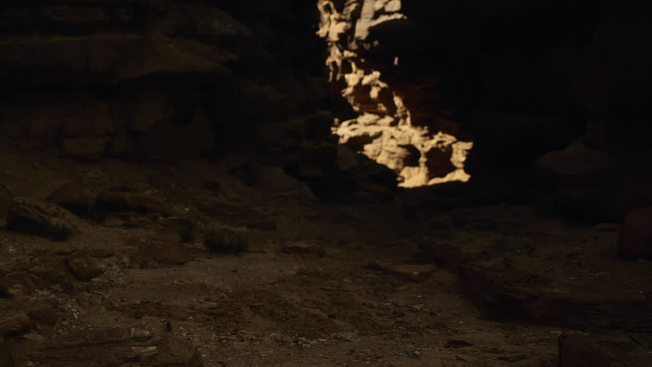 Exploring the dark cave with a glowing entrance revealing sunlight