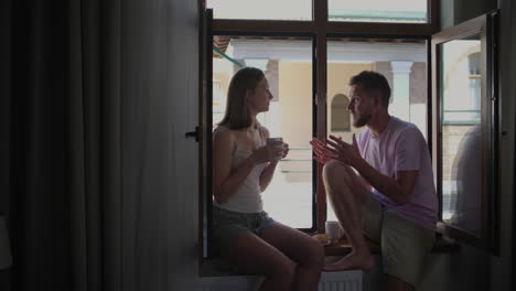 couple talking at window
