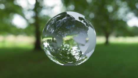 transparent earth globe in a green park