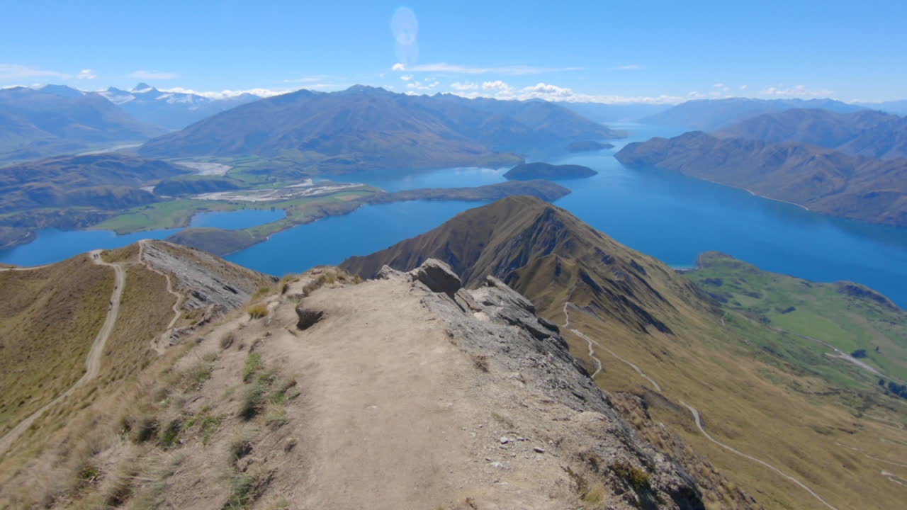 camine a lo largo del borde del tren roys peak con el impresionante lago wanaka en el fondo, punto de vista amplio