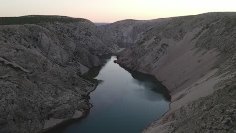 the zrmanja river looks perfectly calm in this slow reversing drone shot