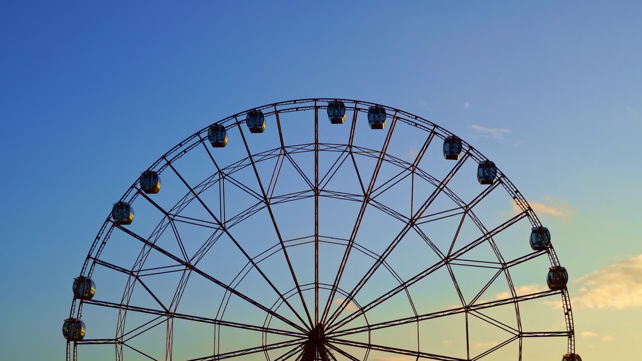 accelerated. Ferris wheel against a blue sky.