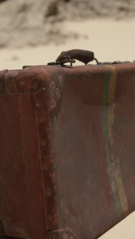 vintage suitcase on sand