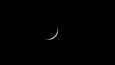 waxing crescent moon at night. - static