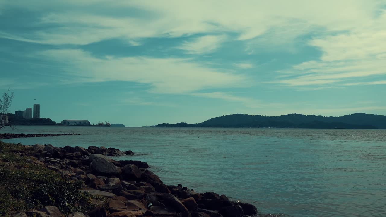 Summer Sunset Beautiful View Of Teluk Likas Beach, White Sandy Beach, Small Island, Blue sea water And Green Trees,Kota Kinabalu,Sabah,Malaysia.