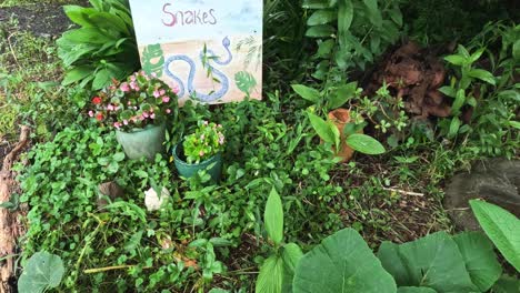 sign unveiling in a lush green garden setting