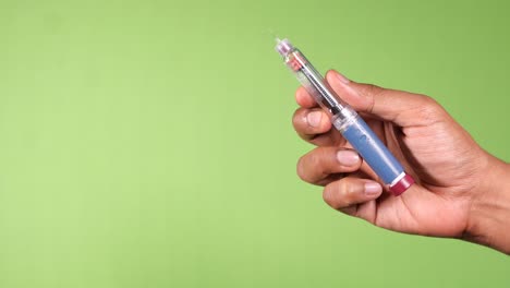 person injecting insulin using an insulin pen