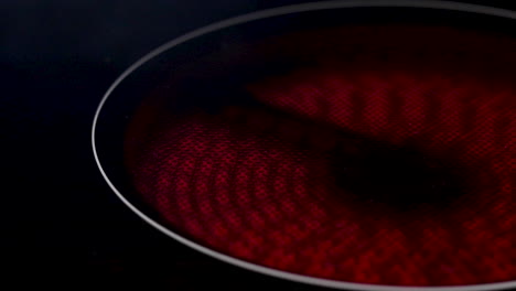 a close up shot of an electric hob or stove heating up and turning red