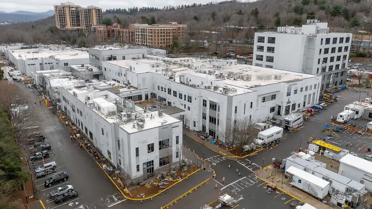 Aerial View of an Expansive Industrial Complex Surrounded by Infrastructure and Nature, Showcasing Modern Architecture and Urban Development