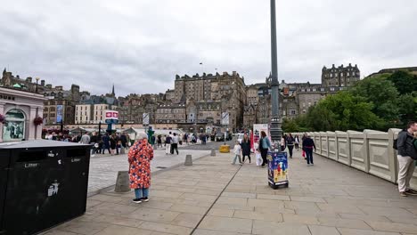 people walking on waverley bridge during festival