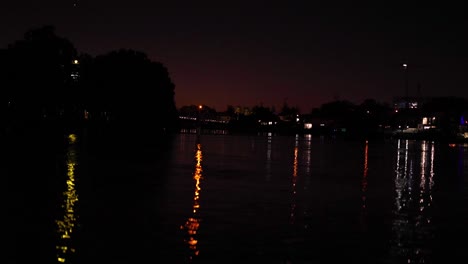 colorful lights blinking on water at night