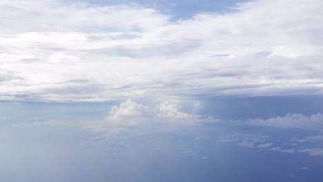 flight over clouds, a view from a plane window - beautiful blue sky