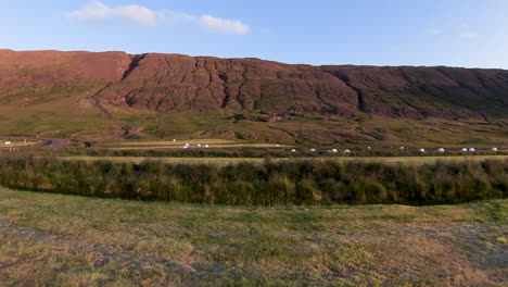 Idyllic-coutryside,-hay-field-and-mountains.-Dolly-shot