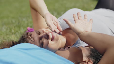 close-up of tired women lying on lawn after intense workout