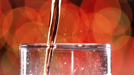 Glass-of-cola.-Ice-cola-with-splashing-bubbles-slow-motion-on-a-blurry-light-,blurry-background.