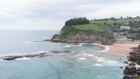 An-aerial-shot-of-beautiful-beach-houses-in-a-scenic-rocky-beach