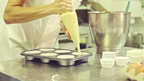 Chef-preparing-muffins-in-kitchen