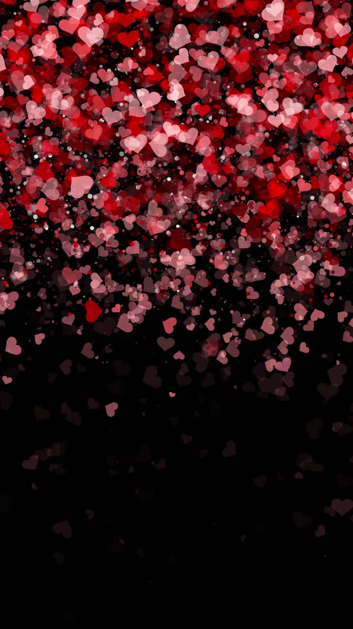 Dark black background of falling small hearts with particle in red colors. Looped festive romantic animation with empty space for text. Vertical video.