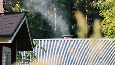 smoke wafts out of a chimney in a mountain resort