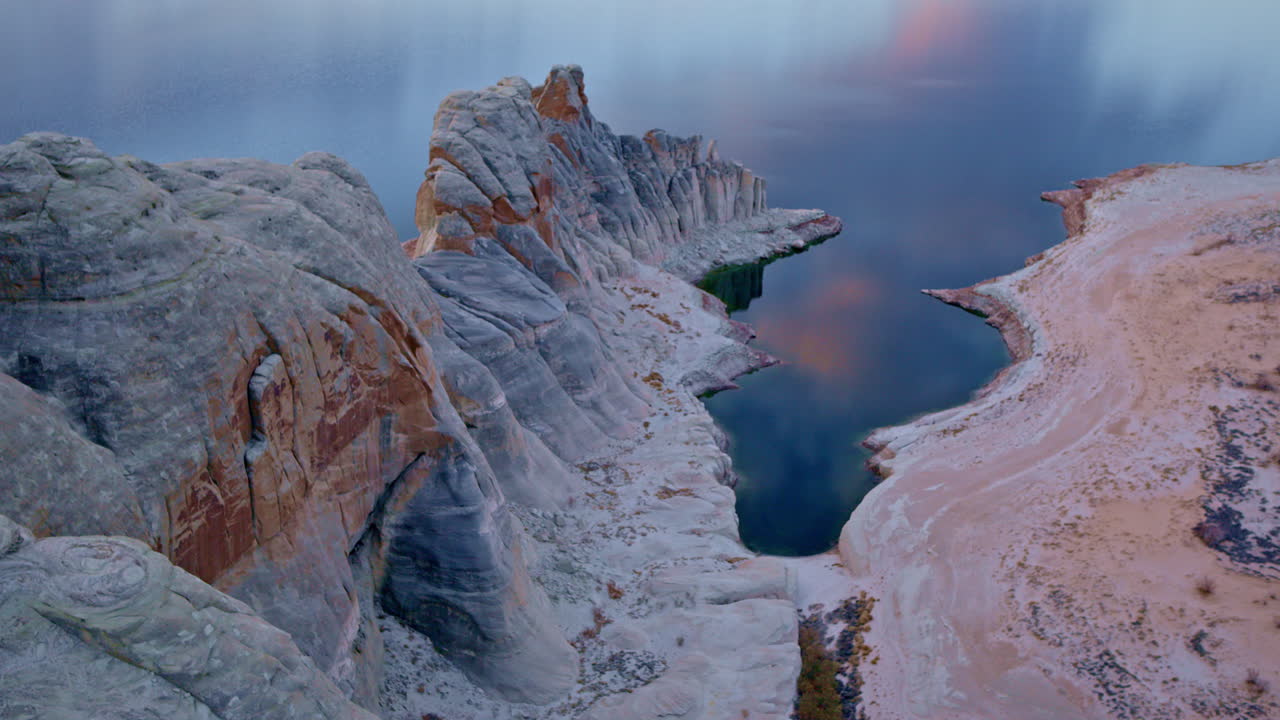 The camera soars through Glen Canyon, capturing the beauty of its time-sculpted rock formations.