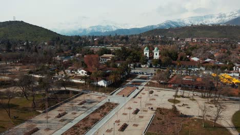 Flying-Over-Plaza-Los-Dominicos-With-View-Of-Church-Of-San-Vicente-Ferrer-In-Las-Condes,-Santiago-de-Chile