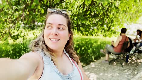 vlogger capturing park atmosphere near pond in athens