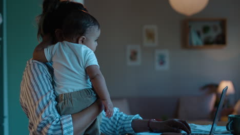 Freelance,-laptop-and-mother-with-baby-at-night