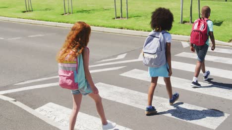 group of kids wearing face masks crossing the road