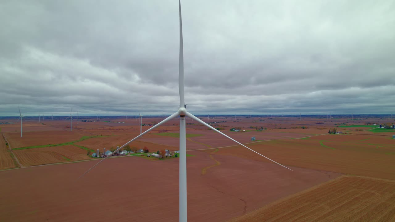 Stagnant wind turbine stands out in Iowa wind farm, blades still, New Sharon, Iowa