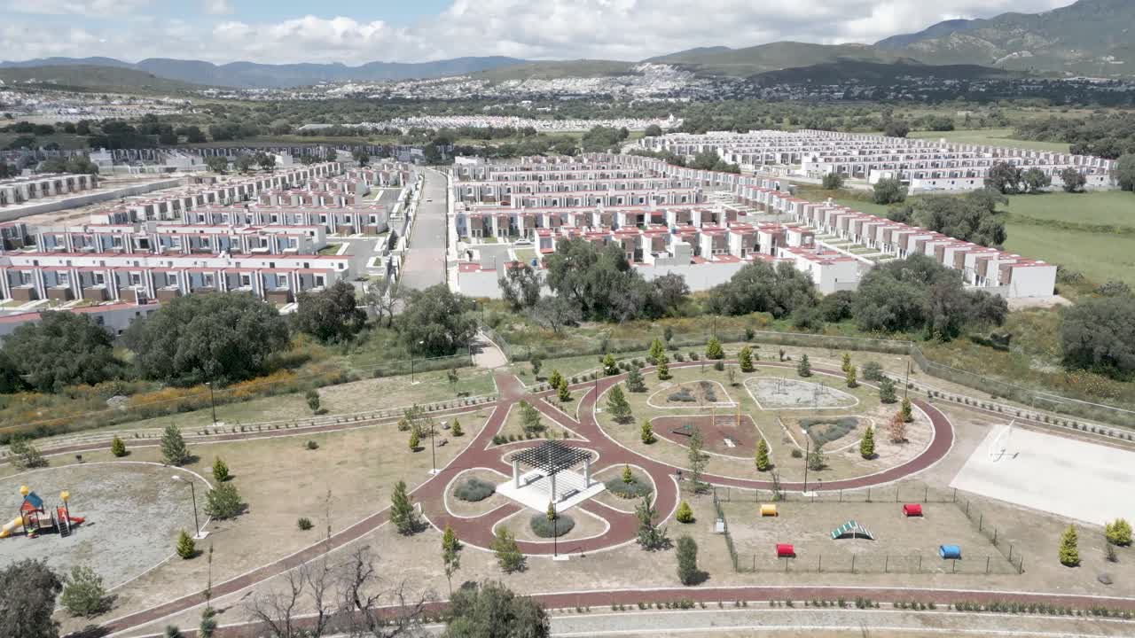 Forward Drone Aerial Reveal Lifting From Top-Down Over Rural Fields Toward Expanding Housing Developments in Mexico – Sunny 4K