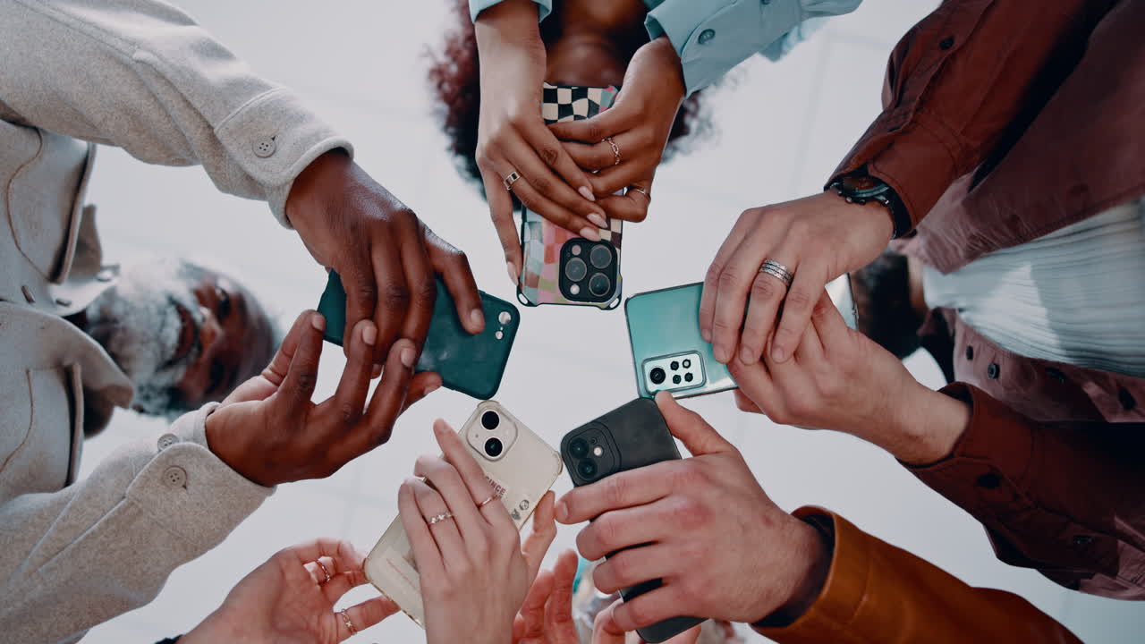 Group of diverse people holding mobile phones