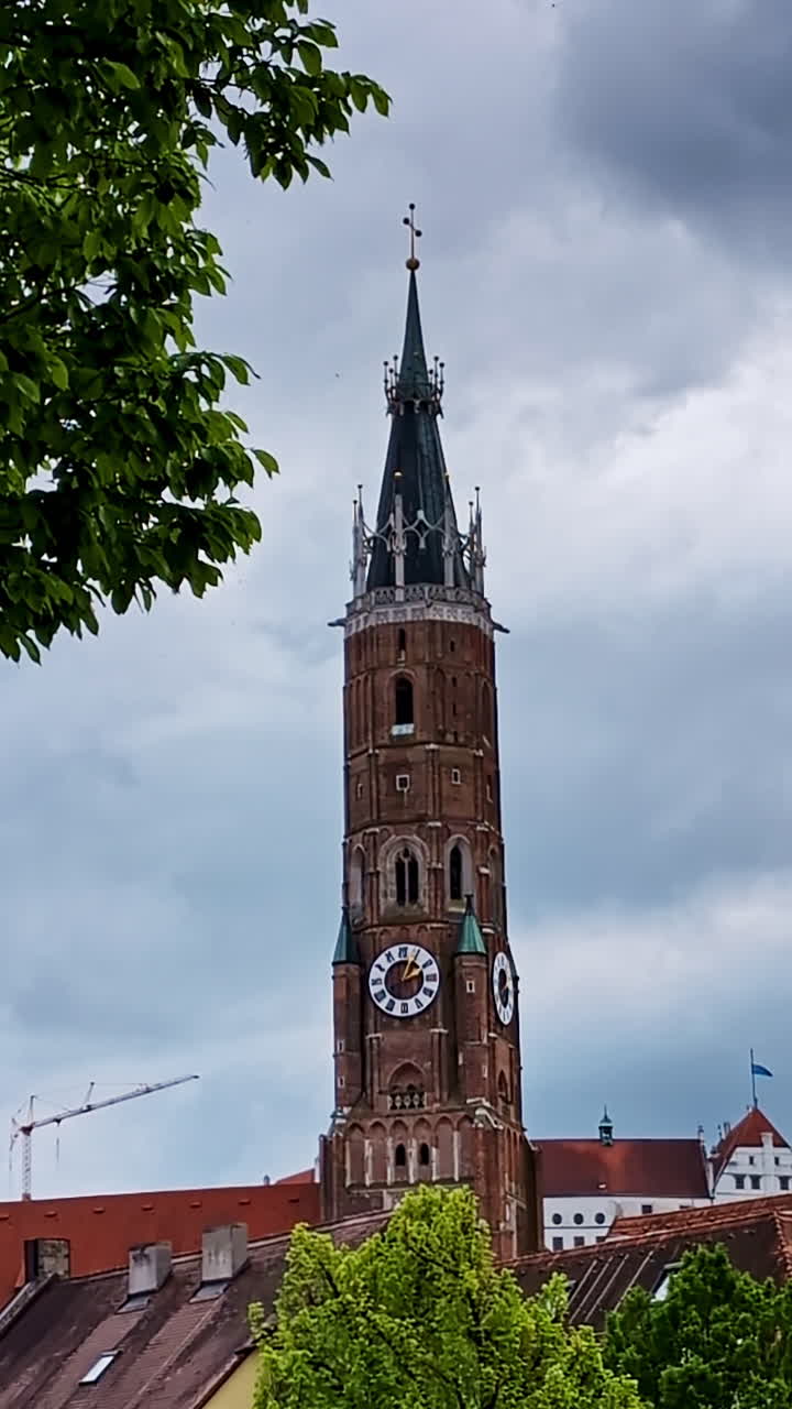 St. Martin’s Church Clock Tower With Overcast Sky in Landshut, Germany, vertical