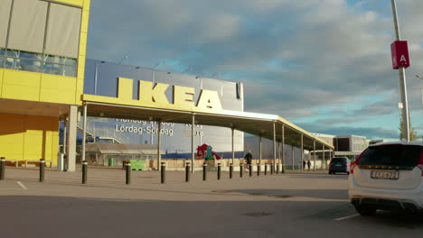 vehicles and a cyclist leave a swedish ikea store