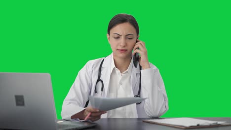 Indian-female-doctor-explaining-medical-report-to-patient-on-call-Green-screen